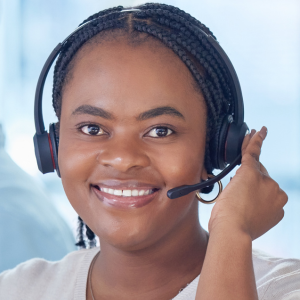 Intake specialist with phone headset on and smiling at camera